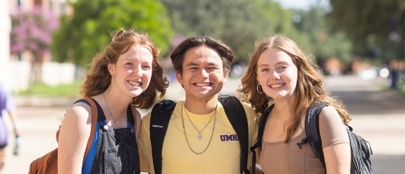Three UMHB students smiling at the camera